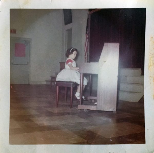 Teresa playing piano as a child