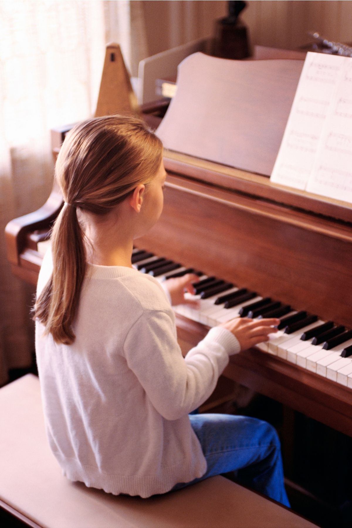 Piano student at piano with metronome Piano student at piano with metronome